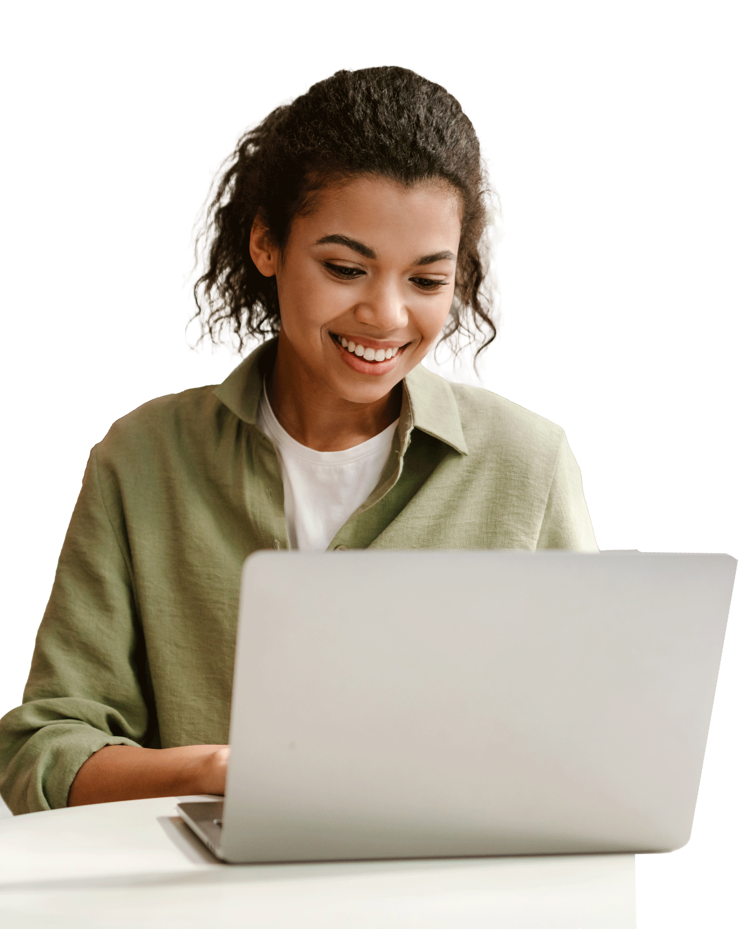 A young female smiling and typing on a laptop